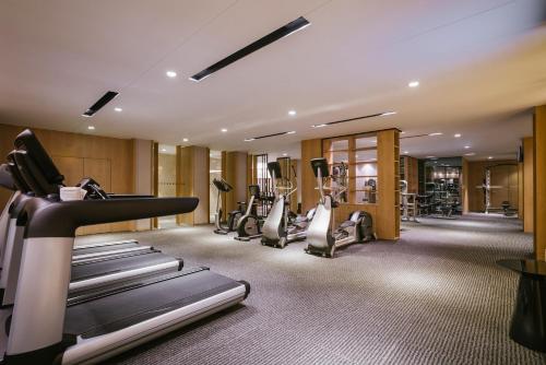 a gym with treadmills and elliptical machines at Pullman Shanghai Jingan in Shanghai