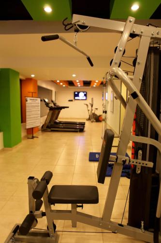 a gym with a treadmill in the middle of a room at Convair Hotel in Ciudad del Este