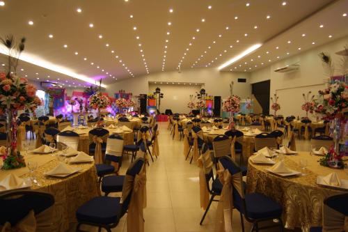 a banquet hall with long tables and chairs at Convair Hotel in Ciudad del Este