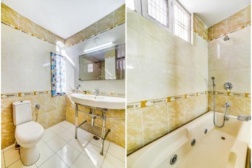 a bathroom with a sink and a toilet and a bath tub at Hotel Kings Corner in Jaipur