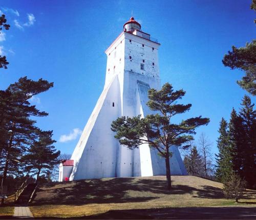 a lighthouse on top of a hill with a tree at Tahkuna tree-house in Malvaste
