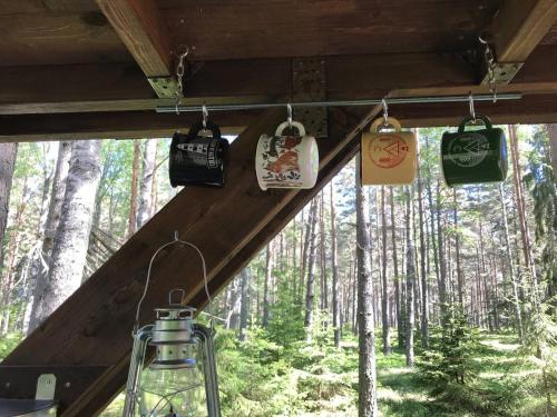 a group of bags hanging from a ceiling in a forest at Tahkuna tree-house in Malvaste