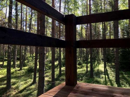 a view from the porch of a cabin in the woods at Tahkuna tree-house in Malvaste