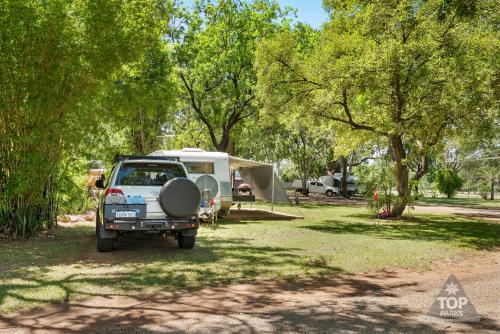 a car parked in a park with a tent at Riverview Tourist Village in Katherine