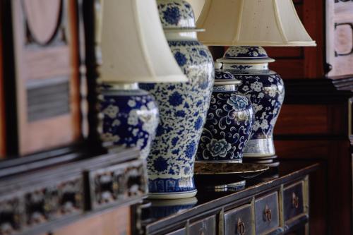 three blue and white vases sitting on a dresser at The Postcard Galle in Galle