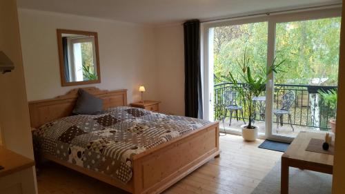 a bedroom with a bed and a large sliding glass door at Sieben-Berge-Haus in Brüggen