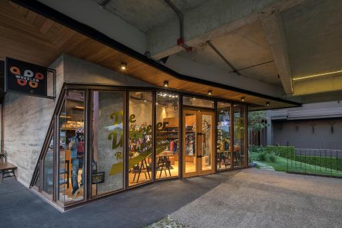 a store front with glass doors on a building at Wheeler Bed &Bike in Bangsaen