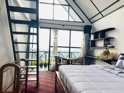 a bedroom with a bed and a large window at Sherwood Cottage in Nuwara Eliya