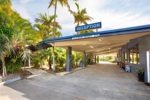 aision gas station with palm trees in the background at Nightcap at Kondari Resort in Hervey Bay