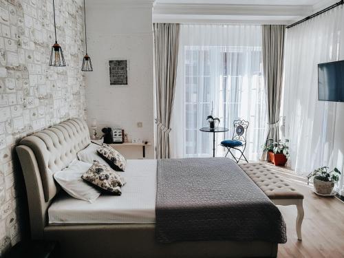 - une chambre avec un lit et une grande fenêtre dans l'établissement Dom Rabinovicha, à Odessa