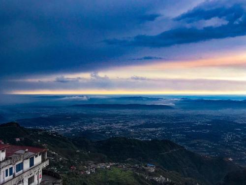 a view of a city from the top of a mountain at The Fern Brentwood Resort, Mussoorie in Mussoorie
