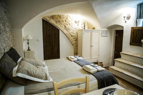 a bedroom with a large bed with two towels on it at HOME 5 - Via Nuova in Putignano
