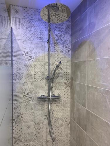 a shower with a glass door in a bathroom at Duplex au cœur de Deauville avec vue imprenable et parking privé in Deauville