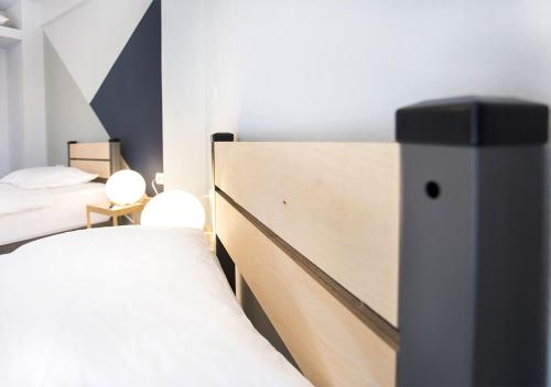a bedroom with two beds and a headboard at Snooze H in Athens