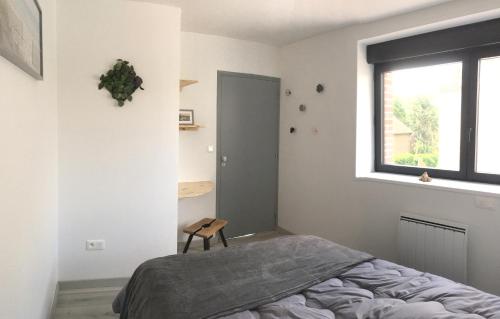 a bedroom with a bed and a window at Gite de sejour la grange de Théophile in Anzin-Saint-Aubin