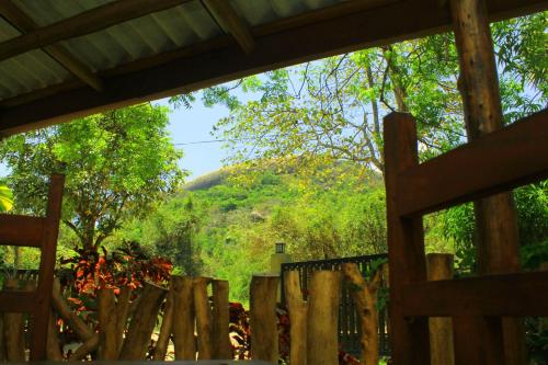 a view from the window of a wooden fence at Thal Sewana in Sigiriya