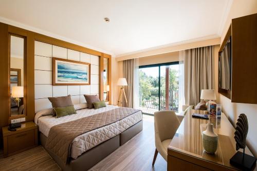 
a hotel room with two beds and a large window at PortAventura Hotel PortAventura - Includes PortAventura Park Tickets in Salou
