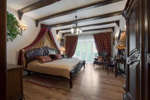 a bedroom with a bed with a canopy at Grand Duke Apartments in Vilnius