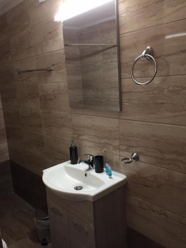 a bathroom with a white sink and a mirror at Villa Makri in Makri