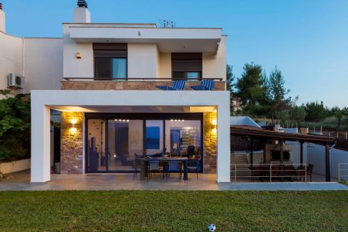 a view of a house with a dining area at Villa Rossa in Hanioti