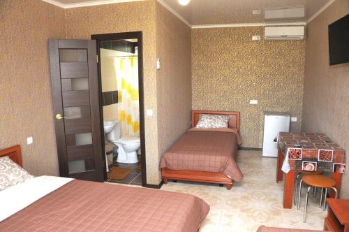 a hotel room with two beds and a bathroom at Solnechnaia Dacha in Zatoka
