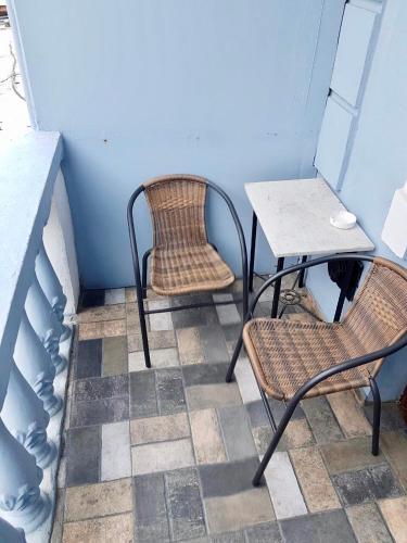 two chairs and a table and a table and chairs at Sweet Home at Ninoshvili 3 in Batumi