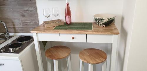 a small kitchen with a counter with two wine glasses at ele&gio accomodation in Tropea