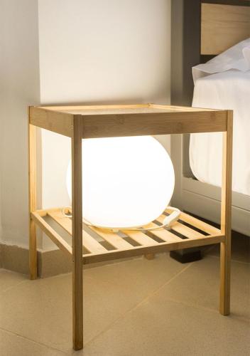 a wooden table with a shelf next to a bed at Snooze H in Athens