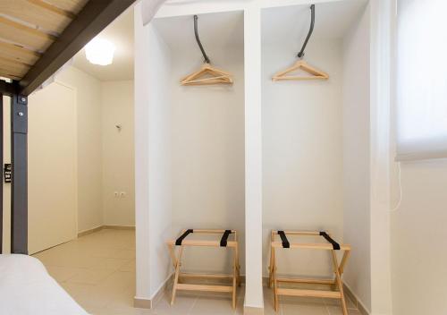 two chairs in a room with white walls at Snooze H in Athens