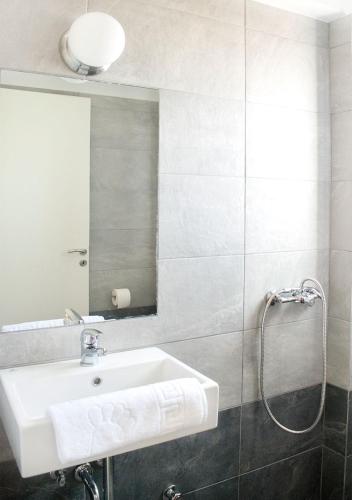 a bathroom with a sink and a mirror at Snooze H in Athens