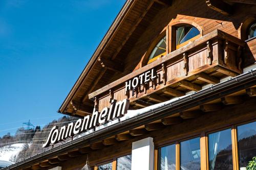 a sign on the side of a building at Hotel Sonnenheim in Sankt Anton am Arlberg