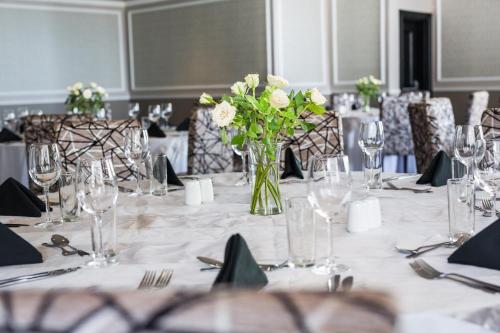 a table with a vase of flowers on it at Premier Hotel Cape Town in Cape Town