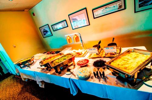 a table with a buffet of food on it at Wescana Inn in The Pas