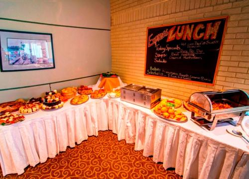 a buffet table with food on it in a room at Wescana Inn in The Pas