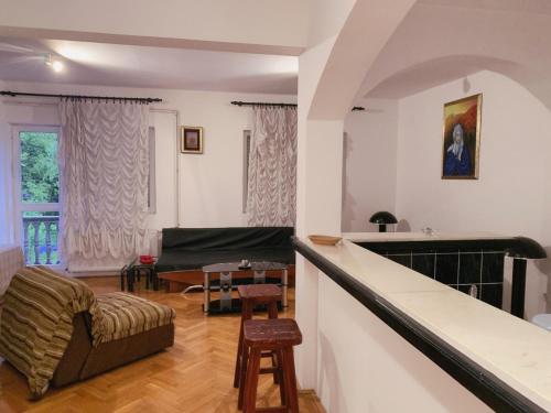 a living room with a couch and a table at Hostel Holiday Cetinje in Cetinje