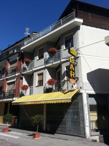 a building with a yellow awning and a sign on it at Dufour Hotel in Châtillon