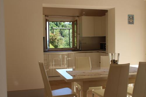a kitchen with a table and chairs and a window at Villa Porsenna in Chiusi