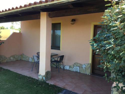 a patio with a table and chairs next to a house at Hotel Belvedere in Teulada
