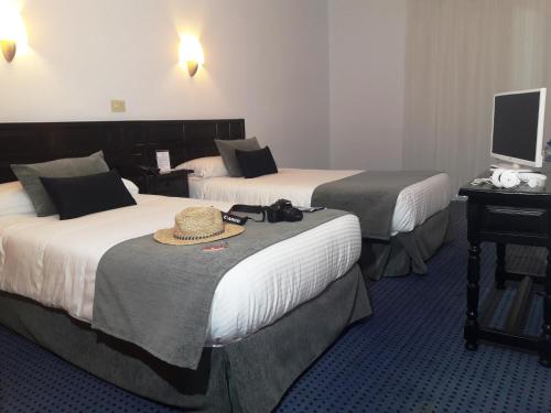 Postel nebo postele na pokoji v ubytování Hotel Miramar