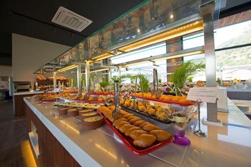 a buffet line with a variety of pastries on display at Belcekum Beach Hotel in Oludeniz