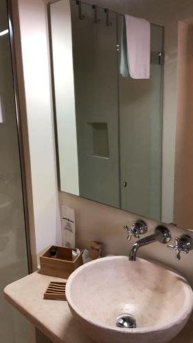 a bathroom with a sink and a mirror at Masseria Capece in Cisternino