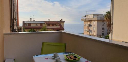 a room with a table and a view of the ocean at ele&gio accomodation in Tropea