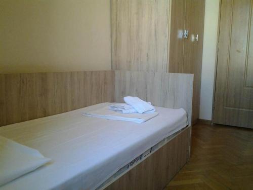 a bed with two towels sitting on top of it at Old Tbilisi Flavor for You in Tbilisi City