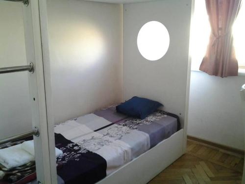a small bed in a room with a window at Old Tbilisi Flavor for You in Tbilisi City