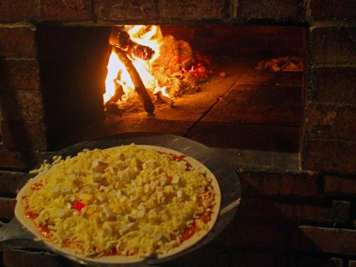 a pizza is cooking in a brick oven at Serrambi Resort in Porto De Galinhas