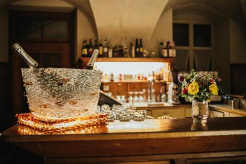 a bar with a cake and flowers on a counter at Historic Hotel Albrici in Poschiavo