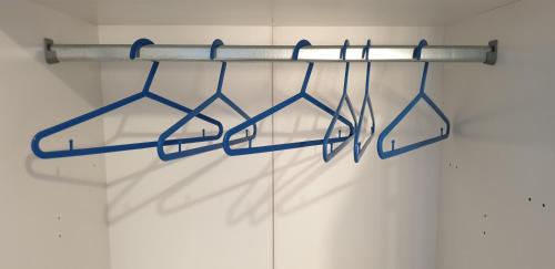a towel rack with blue handles in a closet at ele&gio accomodation in Tropea
