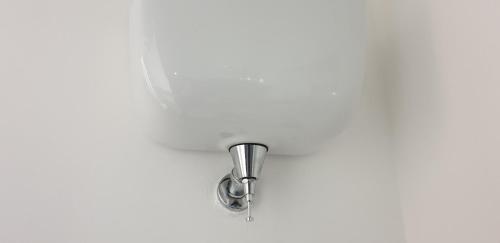 a chrome shower head on a white wall at ele&gio accomodation in Tropea