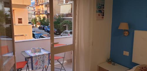 a room with a balcony with a view of a street at ele&gio accomodation in Tropea