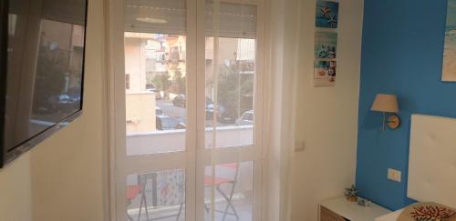 a glass door with a view of a street at ele&gio accomodation in Tropea